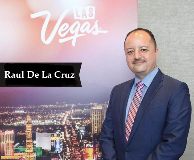 Man in Suit standing in front of sign