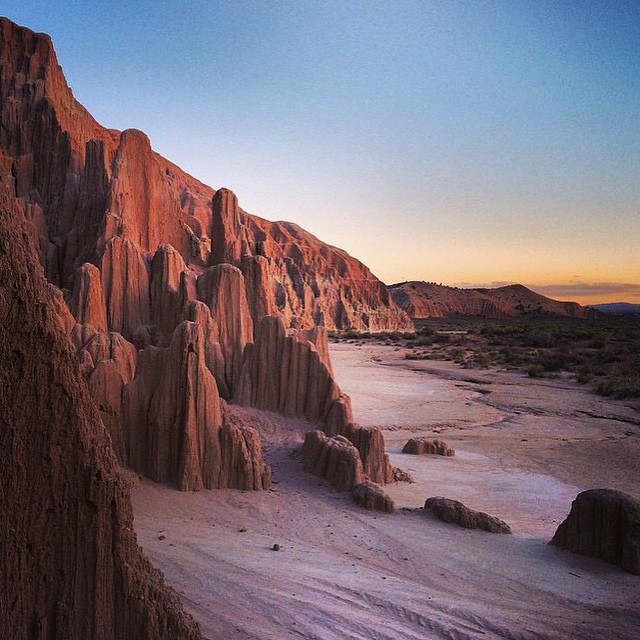 Beautiful Southern Nevada landscape with colorful sunset peaking over the mountains and blue sky
