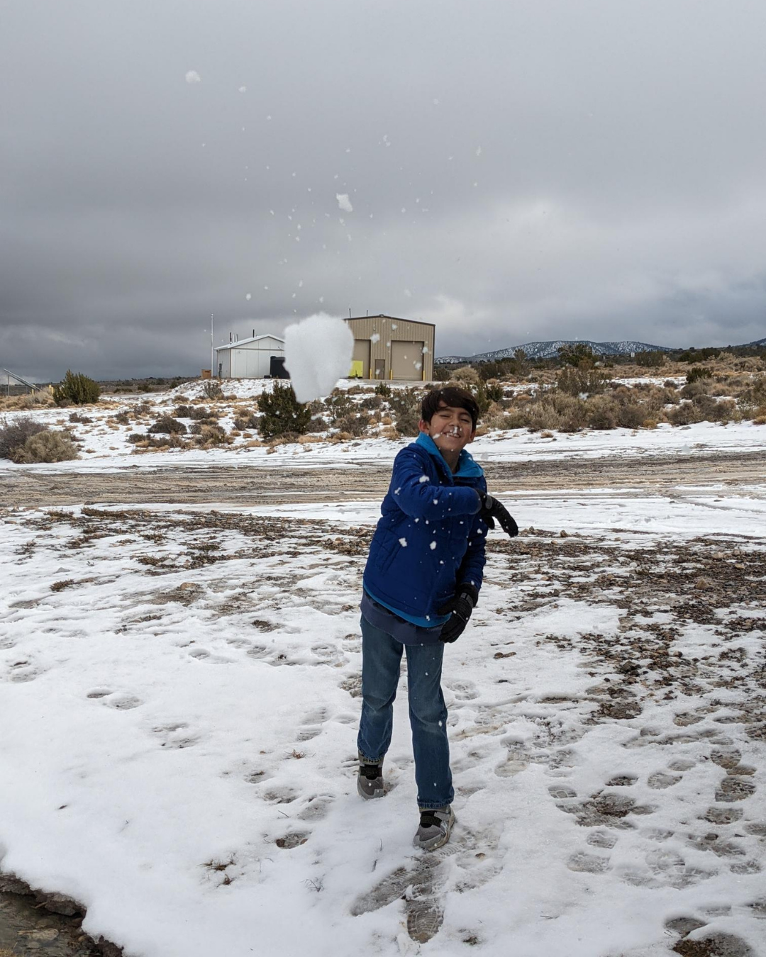 Child throwing snowball at camera in Cold Creek Nevada