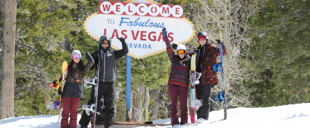 Four skier and snowboarders by Lee Canyon Welcome to Las Vegas sign