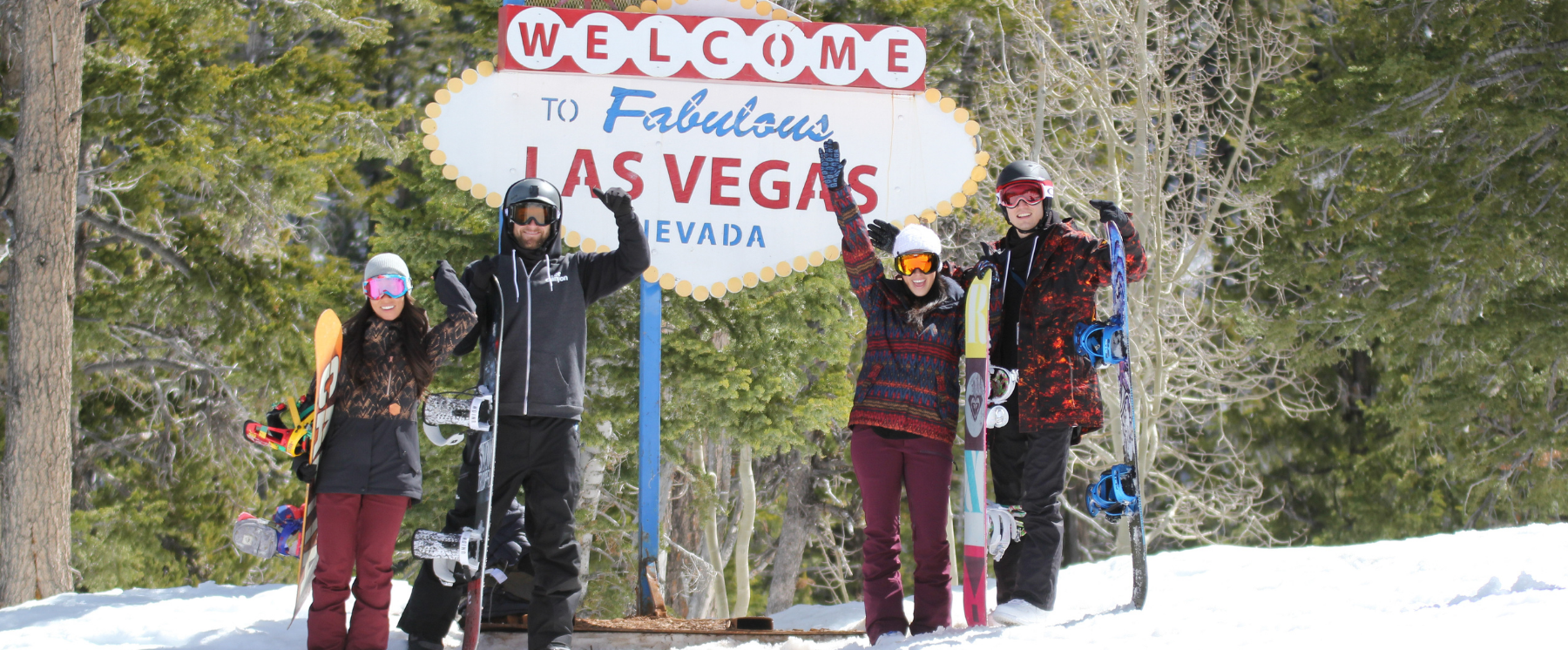 Four skier and snowboarders by Lee Canyon Welcome to Las Vegas sign