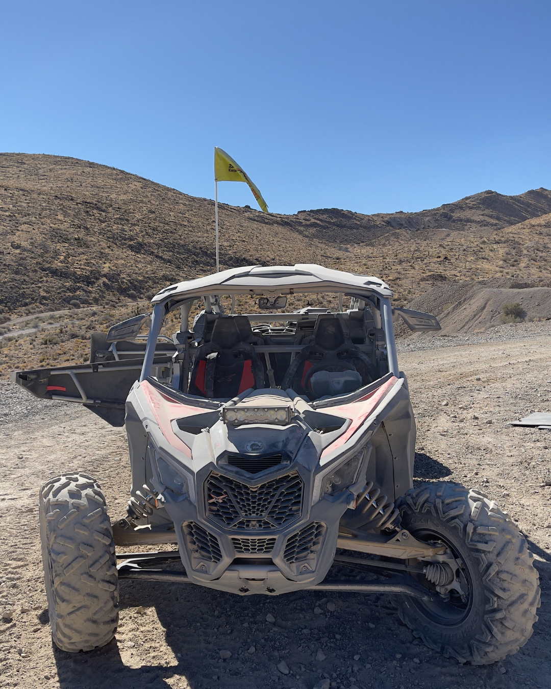 UTV sitting on Adrenaline Mountain under a blue sky