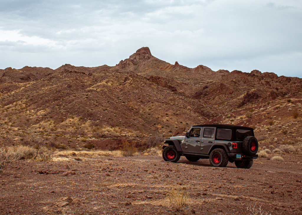 Vegas Jeep Tours four door slate grey jeep in the brown mountain terrain outside of Las Vegas