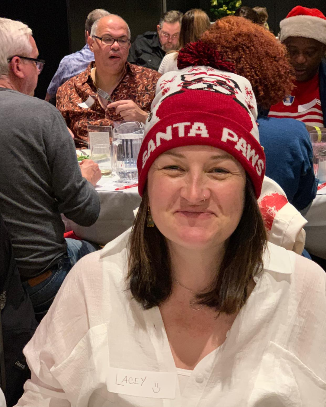 Shows in Vegas girl wearing santa paws red hat at Marriage Can Be Murder