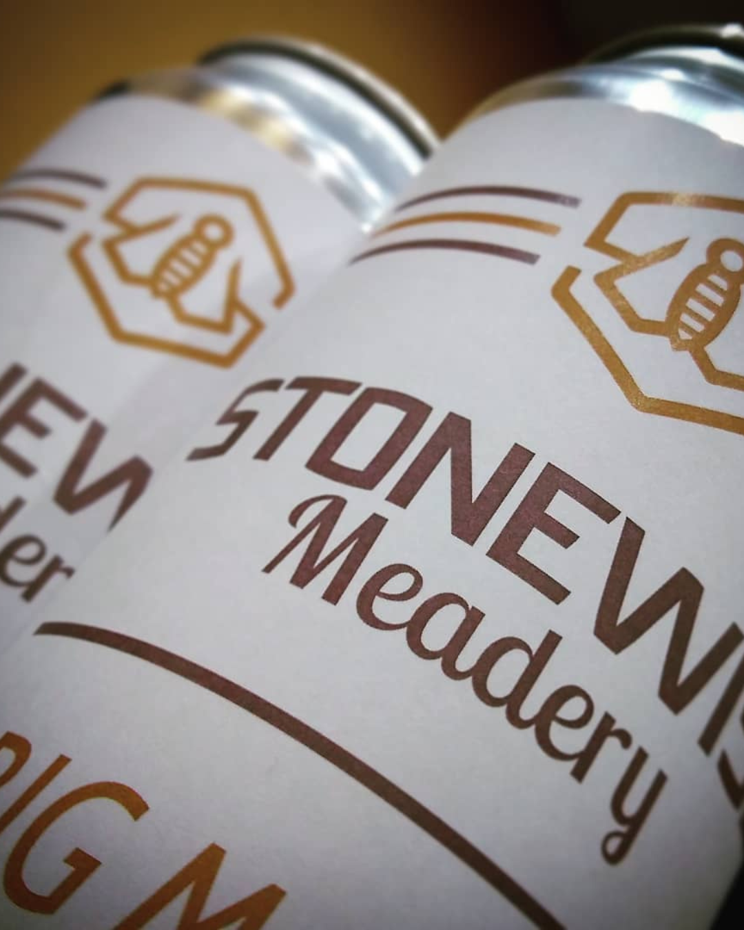 A with gold and brown beer can with the stonewise meadery font and logo