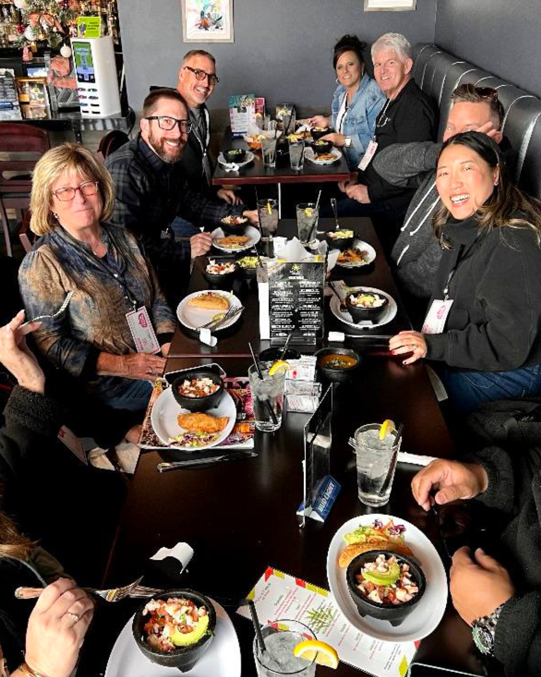 Six people sitting around a table of food on a Taste Buzz tour.