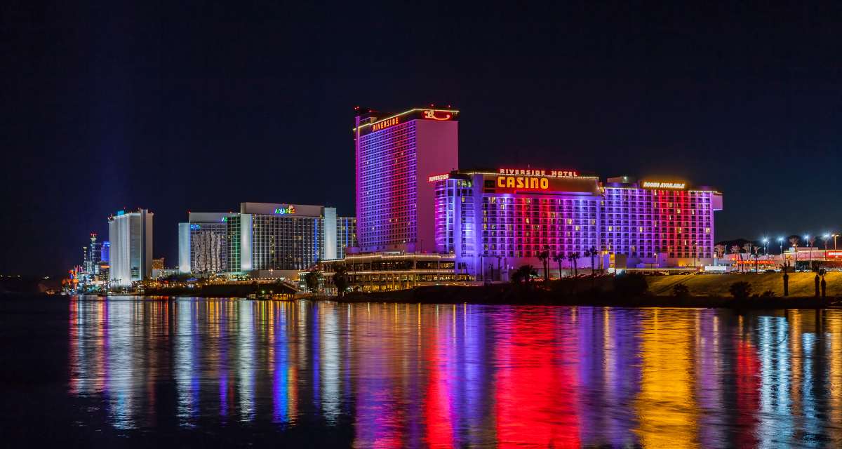 Laughlin Nevada lit up at night with the Colorado River in the foreground