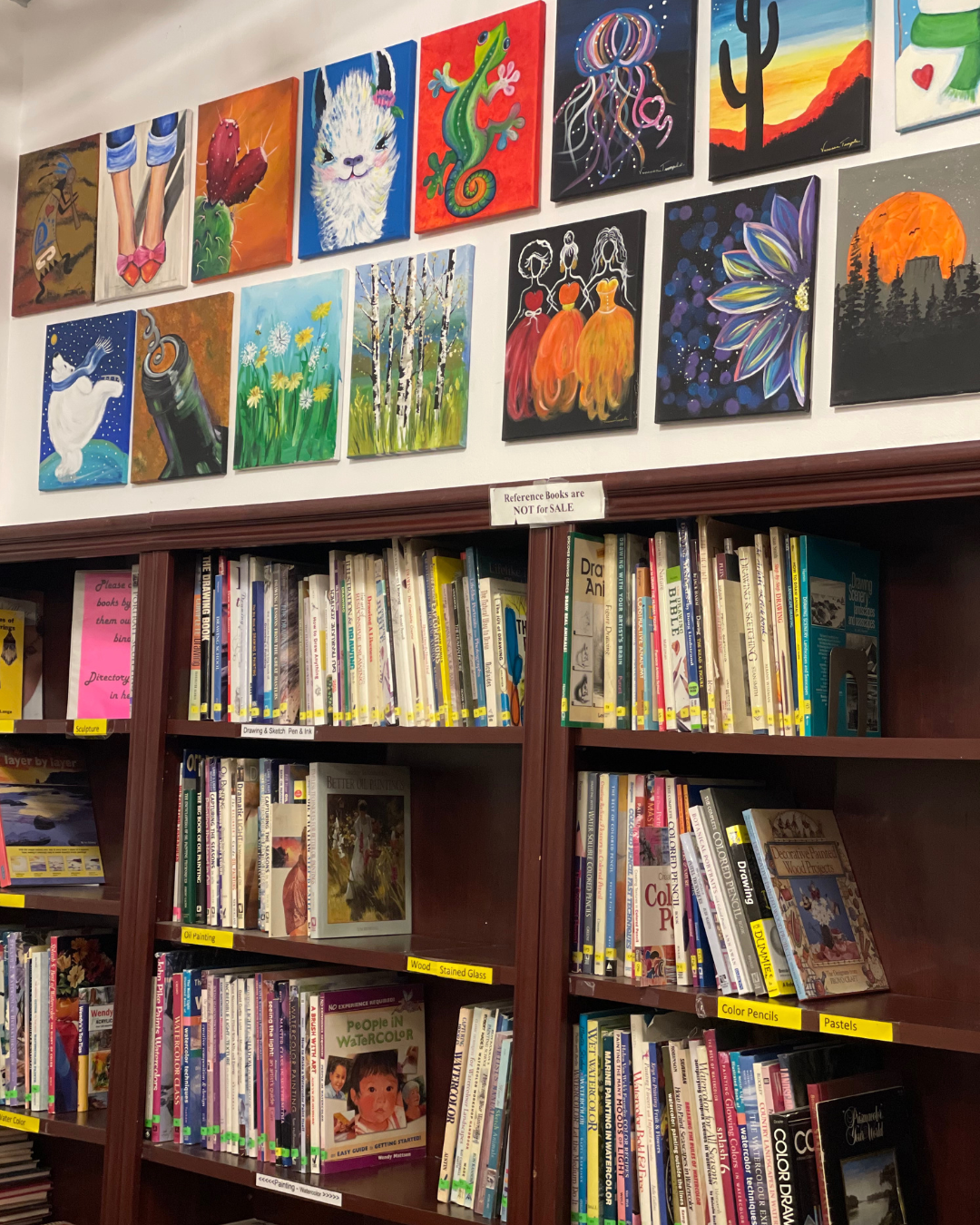 Two rows of art on top of a bookshelf of reference books inside the Virgen Valley Heritage Museum