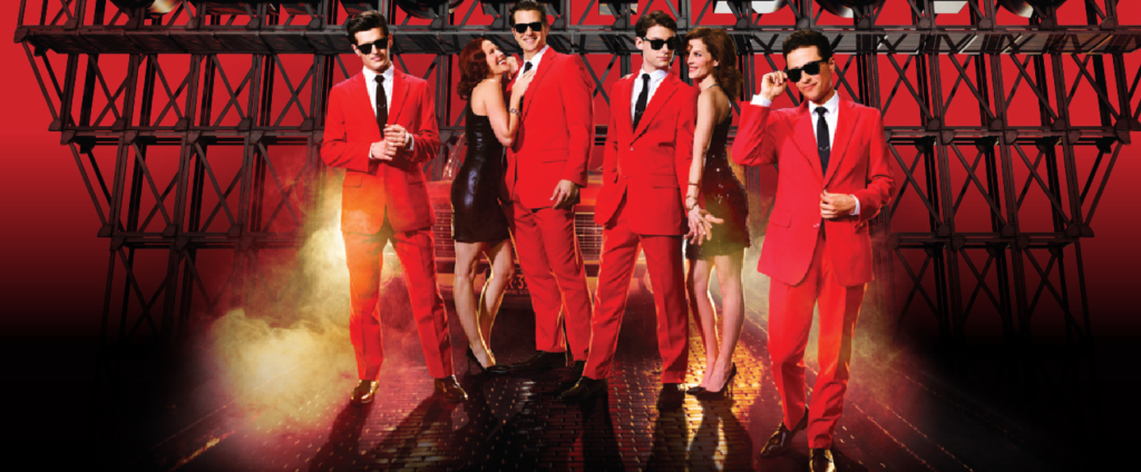 a stock ad image from the jersey boys showing the guys in red suits flanking girl.