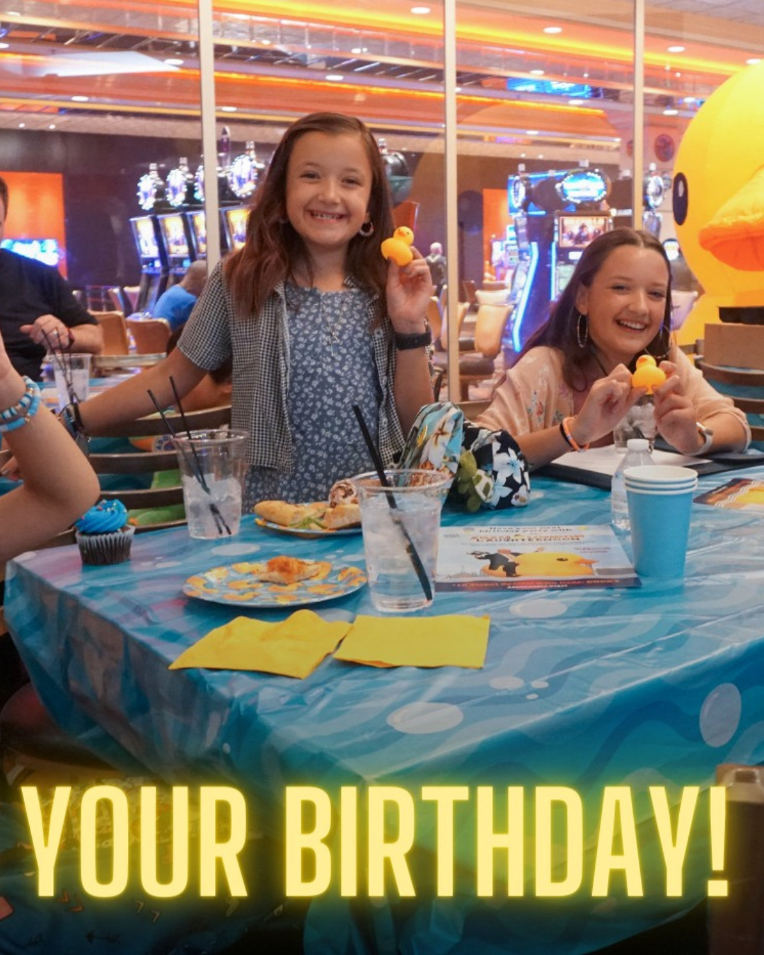 Two youngsters holding ducks at an Adam London Laughternoon group birthday party with pizza.