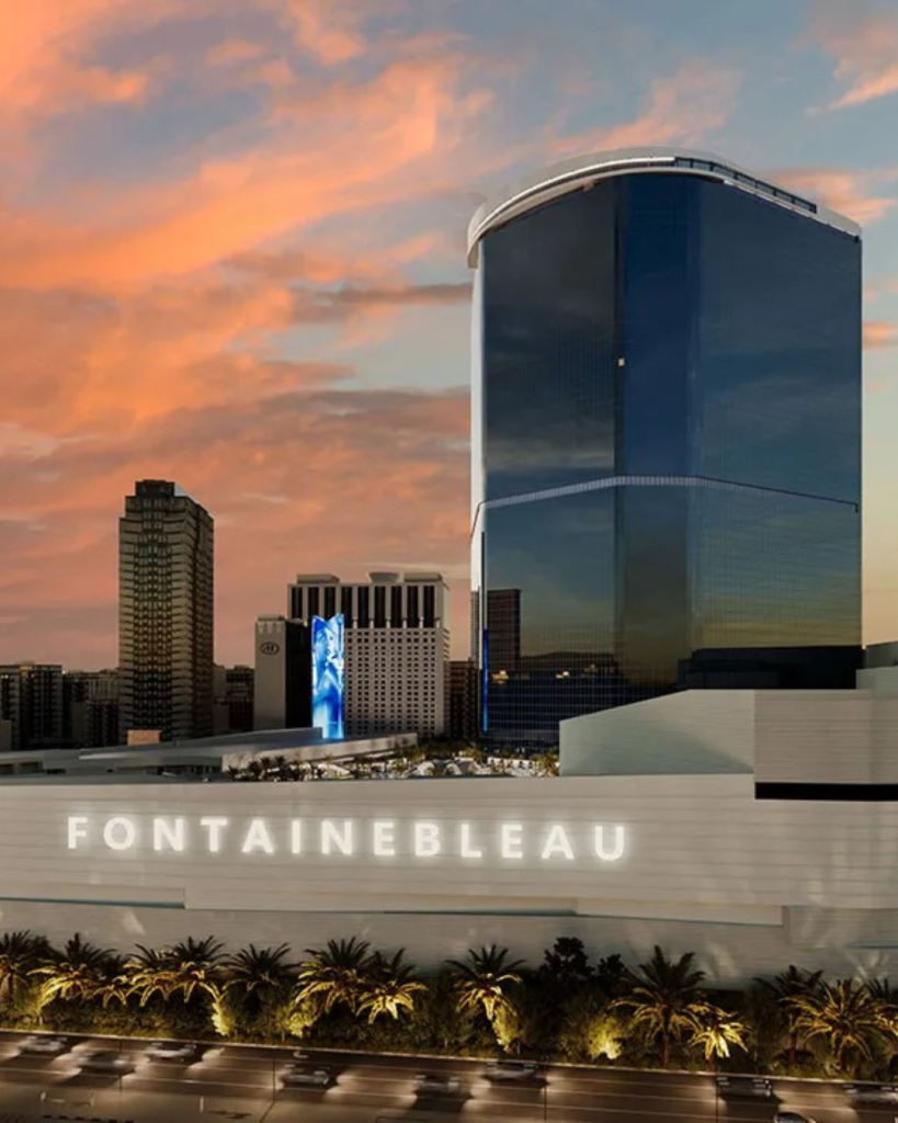 The exterior Fontainebleau with a cloudy orange sky from the sunset.