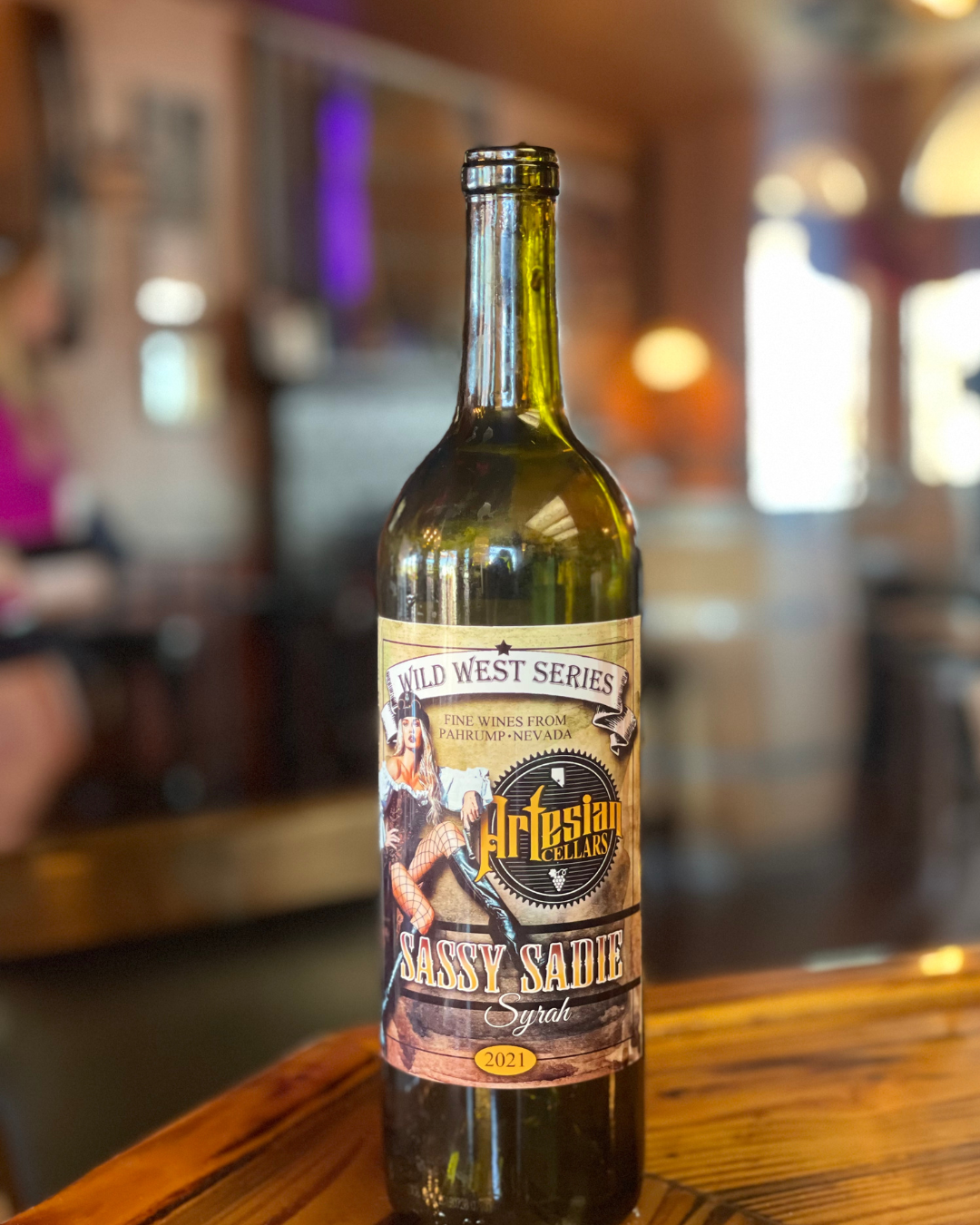 A bottle of red wine from Artesian Cellars in Pahrump....Sassy Sadie Syrah from the wineries Wild West series.