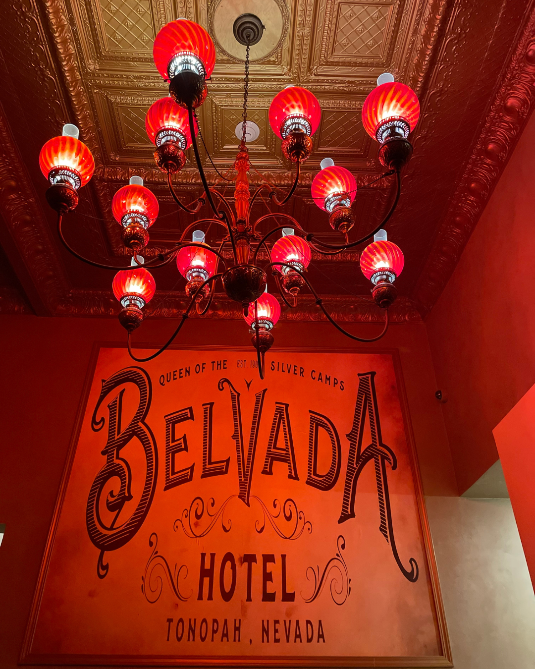 Another haunted motel in Tonopah, the Belvada Hotel. Pic is and inside veire with an old sign a below a red chandler.