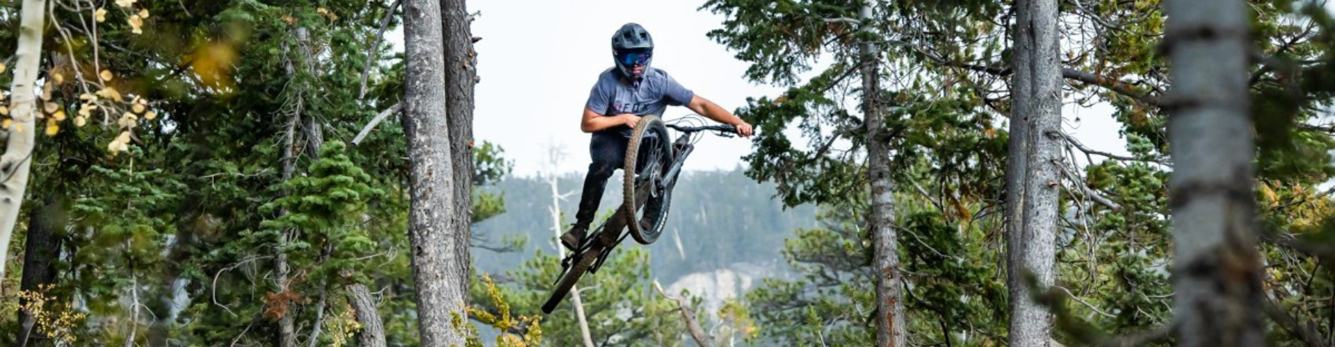 Summer travel begins! This biker is keeping in cool in Lee Canyon flying high on the mountain bike trail after stunting on the course.