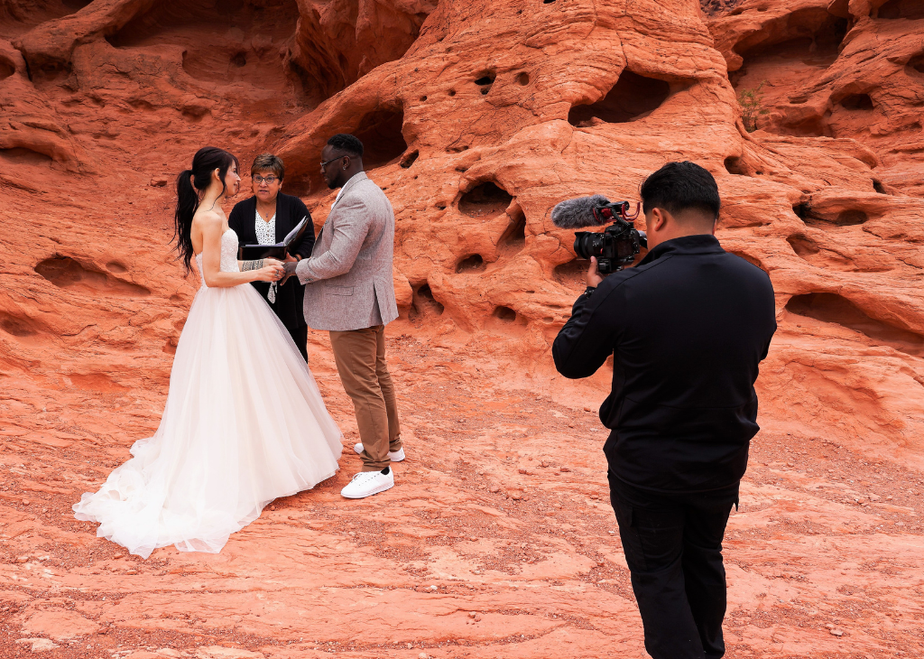 A couple getting married at Valley of Fire - shot includes behind the scenes with videographer tapping the ceremony.
