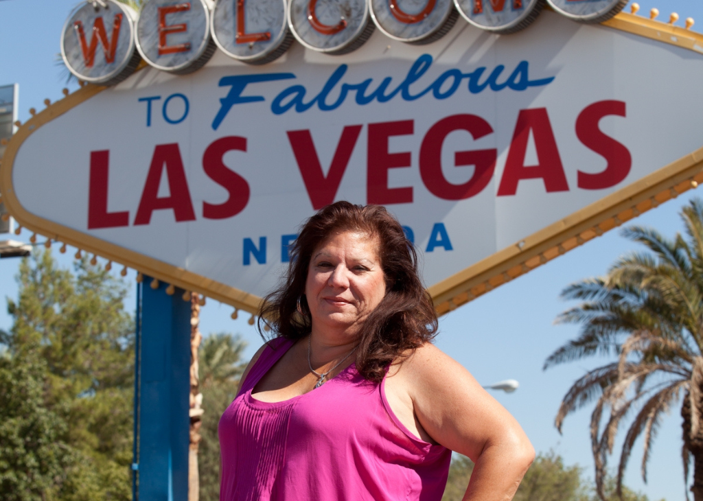 Wedding expert Joni Moss Graham poses in front of the Welcome to Las Vegas sign. She owns LV Wedding Connection.