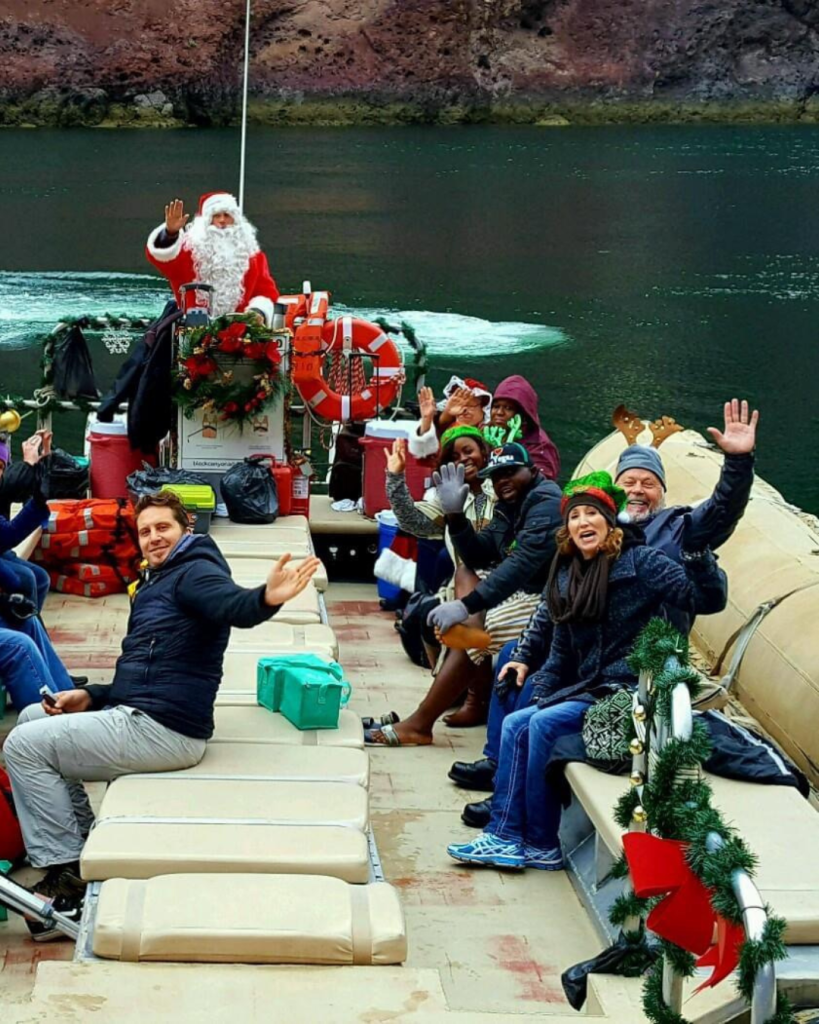 A group of people on a boat with Santa Claus, celebrating the festive spirit in Las Vegas Territory.