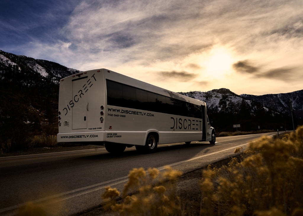 Discreet Party Bus is more than a party! It can take you from neon to nature as shown with the beautiful sunset photo of the bus driving.