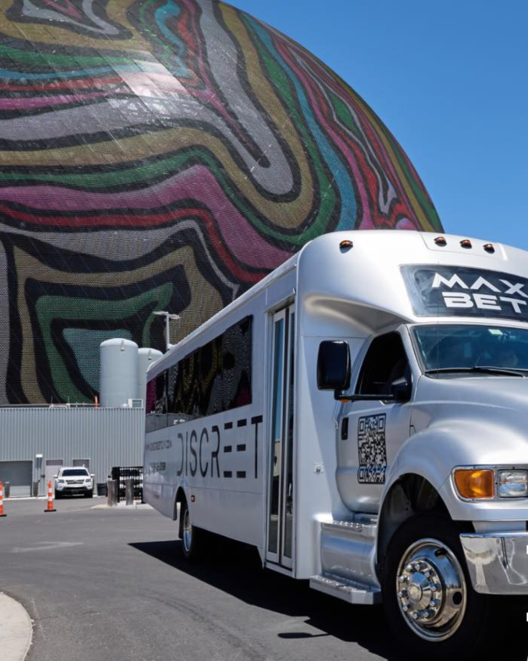 A Discreet Transportation party bus in front of Sphere.