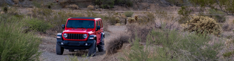 A red jeep parked on a desert road near Boulder City. Our guest road tripper rented it from Vegas Jeep Tours.