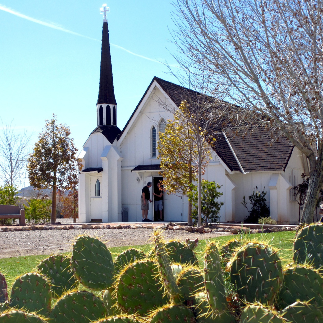 Destination Henderson. The Candlelight Wedding Chapel is a building that you can tour at museum. It is pictured on a sunny day, with cati bloom in the photo's forefront.