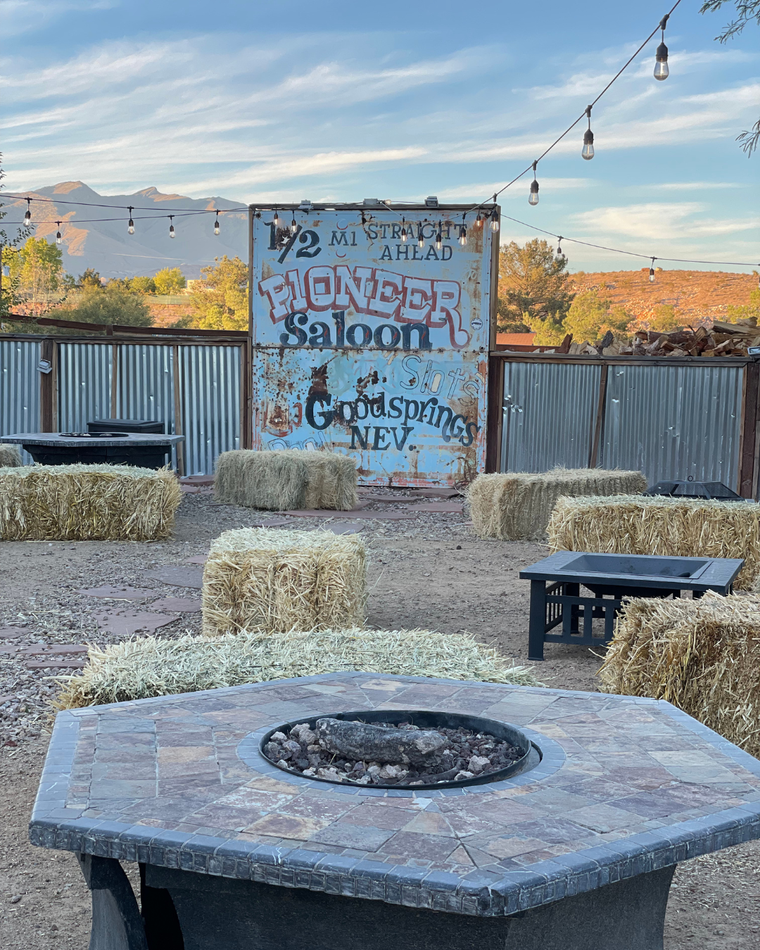 Outdoor seating area of the Pioneer Saloon with hay bales and fire pits. This is a must stop when planning a 3 days around Las Vegas itinerary.