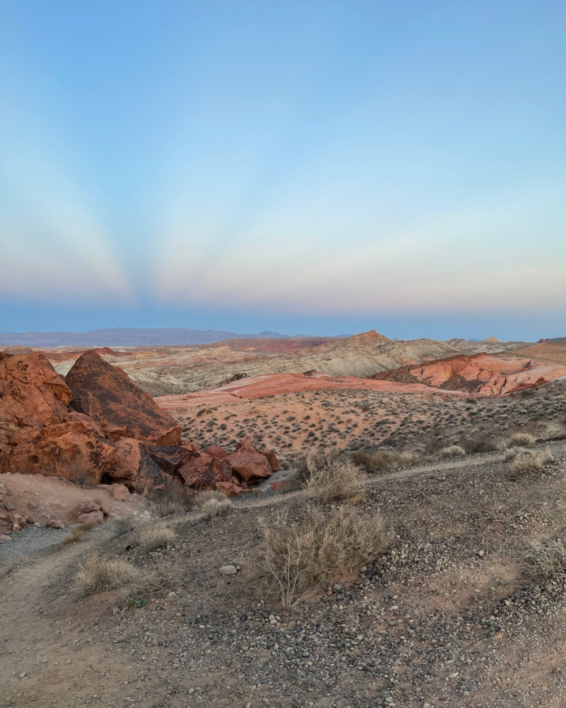 Valley of Fire is located about one hour from Las Vegas and this shot during sunset with waves of blue, pink, orange, white and purple shine above the red and orange rocks.